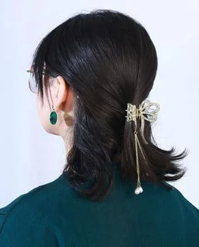 Back hairstyle featuring silver bow-shaped crystal hair clip Stock Photos