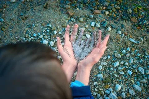 Back of the Head, Two Hands Together Partially Covered with Wet Coarse Sand, Stock Photos