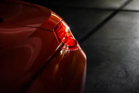 Back headlight of a modern luxury red car in the garage Stock Photos