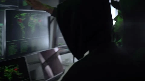 Back hooded hacker using malicious software hack corporate data center Video stock 219725659