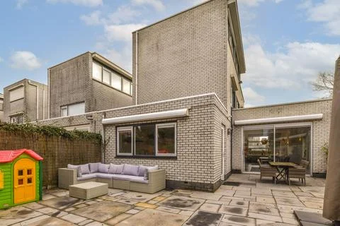The back of the house has a patio and a Stock Photos