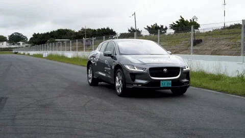 Back of jaguar i pace electric gray car on race track Stock Footage 155607403