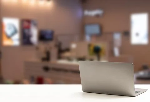 The back of the laptop is blank, placed on a white desk, and nobody, no peo.. Stock Photos