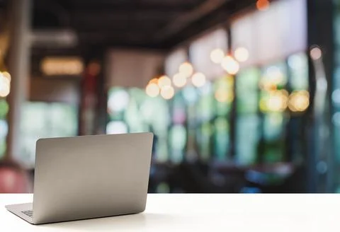 The back of the laptop is blank, placed on a white desk, and nobody, no peo.. Stock Photos