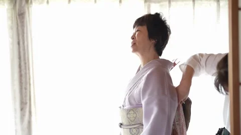Back of lavender kimono adjusted in slow motion Stock-Footage 344015565