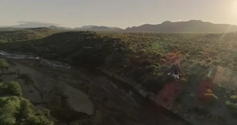 Back light aerial pull revealing Safari lodge in Samburu national park Stockbeeldmateriaal 153162848