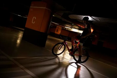 Back light cyclist posing in a garage Stock Photos
