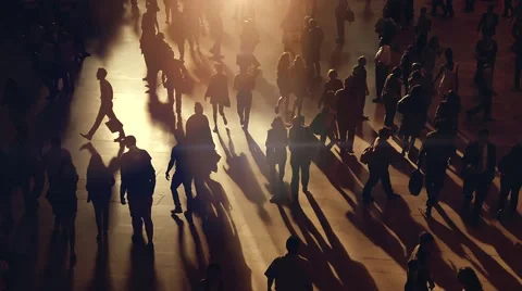 Back light silhouette of people walking on crowded street at sunset Stock Footage