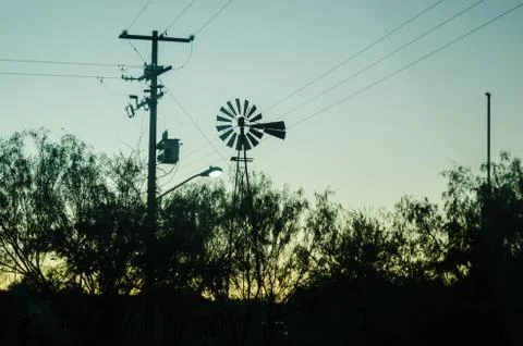 Back light windmill, shadow of a mill next to a lamppost, in the beautiful su Stock Photos