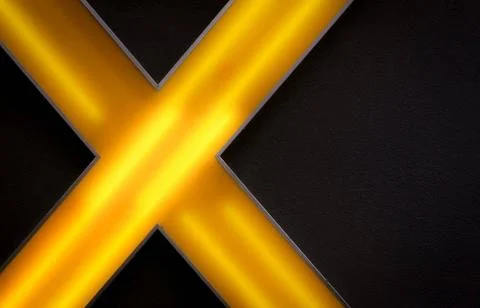Back-lighted yellow abstract cross on black wall of a hotel Back-lighted y... Stock Photos
