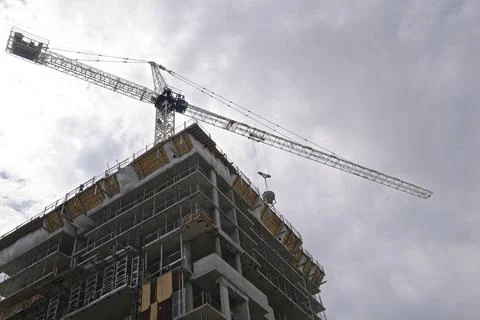 Back lit of the construction building with crane in the construction site Stock Photos