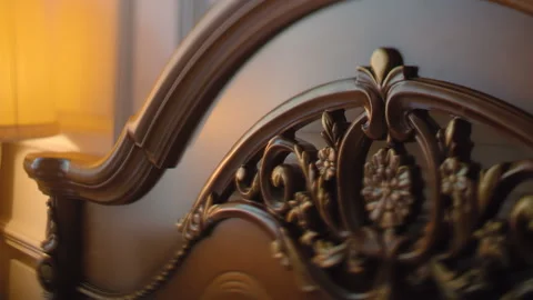 The back of a luxury expensive bed with a beautiful and impressive carving Video stock 119494245