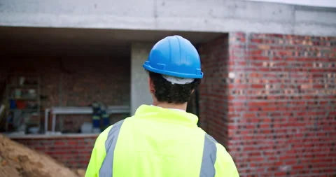 Back, man and architect walk at site, inspection and safety check for Stock Footage 341571665