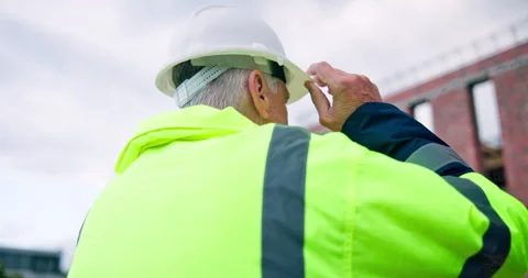 Back, man and engineer at construction site with hard hat, safety and inspection Stock Footage 337036483