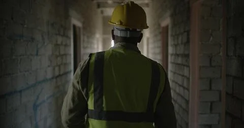 Back, man and engineer walking at construction site for inspection, project.. Foto stock
