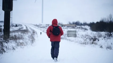 Back man with backpack run along in winter mountains snow lifestyle equipment Stock Footage 105204679