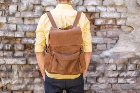 Back of man with brown leather backpack Stock Photos