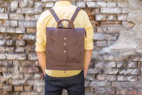 Back of man with brown leather backpack Stock Photos