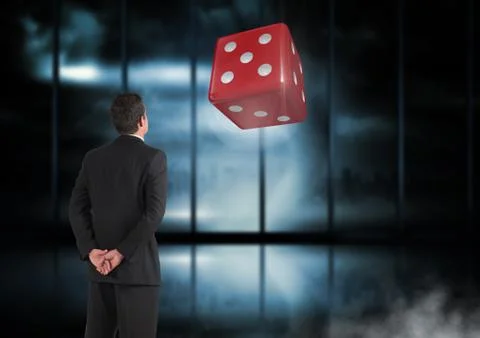 Back of Man Looking at 3d dice 写真素材