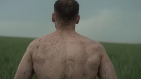 The back of a man, a man walks in the field Stock Footage 129105265