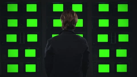 Back of Man Watching Green Screen Televisions, TV Wall Monitors Stock-Footage 161952390