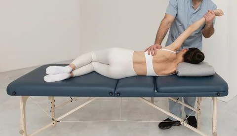 Back massage. Chiropractor or osteopath fixing back during visit in manual Stock Photos