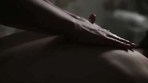 Back massage in the spa. The back is rubbed with oil. Stock Footage 162961564