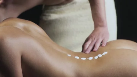 Back massage therapy session. Naked body massage at a spa. Sexy woman enjoying a Stock Footage 314407865