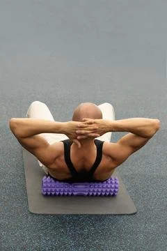 Back massage trigger point using foam roller. Myofascial Release. Stock Photos