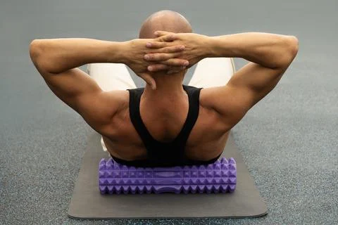 Back massage trigger point using foam roller. Myofascial Release. Stock Photos