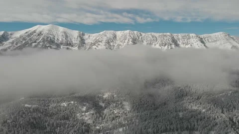 Back up from mountain range in clouds Stock Footage 166500889