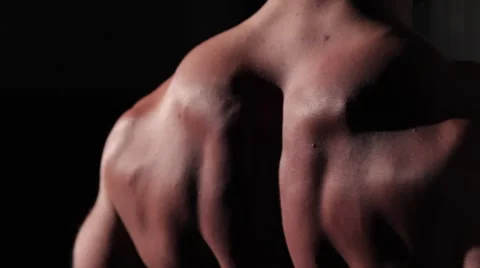 Back muscles close-up. Athlete pumping his body on a machine at the gym Stock Footage 62758940
