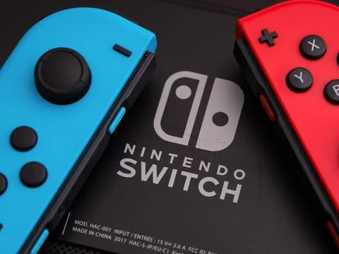 Back of Nintendo Switch video game console with Nintendo Switch logo and two  Stock Photos