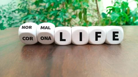 Back to normal turns dice and changes the expression corona life to normal li Stock Photos