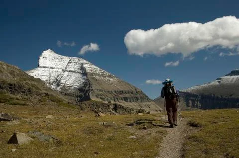 Back packer on snow capped mountain trail Stock Photos