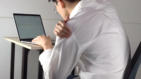 Back pain and massaging while working Stock Footage 130708512