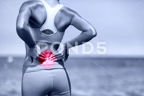 Back pain. Athletic running woman with back injury Stock Photos