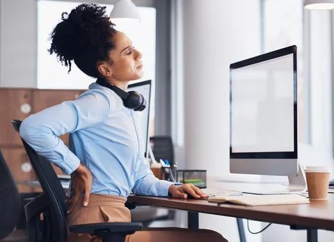 Back pain, call center and business black woman with injury, muscle ache and Stock Photos