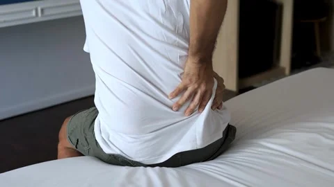 Back pain close up young man has muscle injury discomfort pain wake up with Video stock 336585213