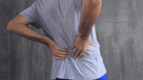 Back pain close up young man has muscle injury discomfort pain wake up with Video stock 336585217