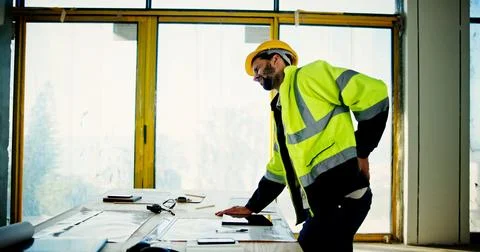 Back pain, construction worker and man in office with stress for injury Stock Photos