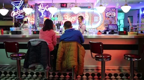 Back of pair in bar in Beverly Hills Diner - network of restaurants Stock Footage 62153196