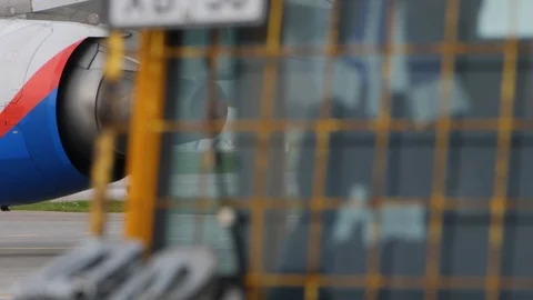 Back part of jet engine. Airliner moves on taxiway at airport. Stock Footage 94513710