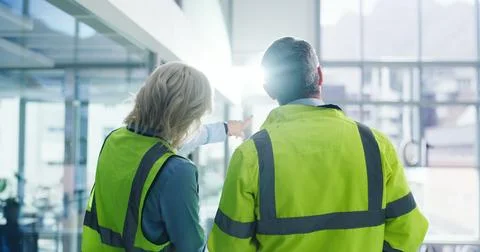 Back, people and engineering with discussion at construction site, building.. Stock Photos