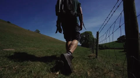 The back of a person walking through the British countryside at dusk Stock Footage 132313180