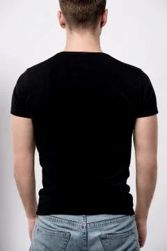 Back pose of young man, looks ahead Stock Photos