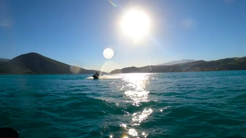 Back POV point of view of male hands riding jet ski on sea Stock Footage 242767205