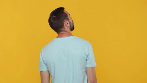 Back rear view confused thoughtful young man 20s in basic casual blue t-shirt Stock Footage 148286405