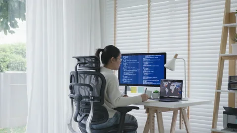 Back rear view of young asian woman, freelance data scientist work remotely 動画素材 142897174