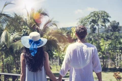 Back Rear View Of Young Couple Holding Hands Over Beautiful Tropical Landscape Stock Photos